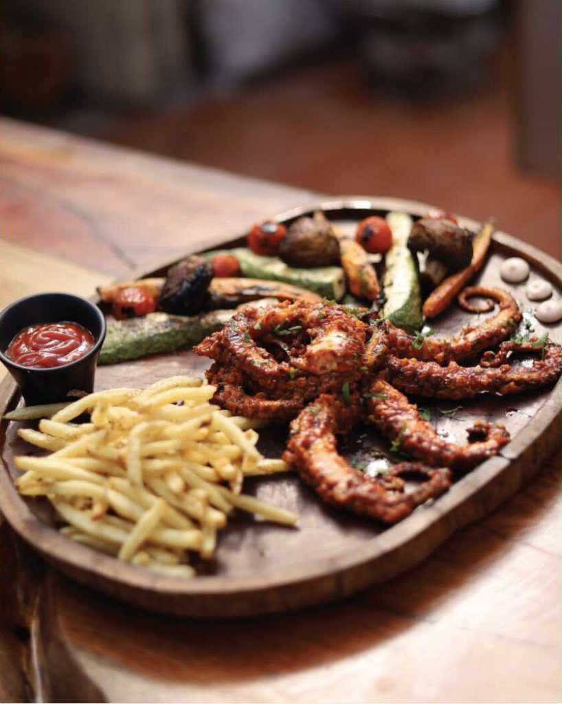 Grilled octopus with fries and roasted vegetables