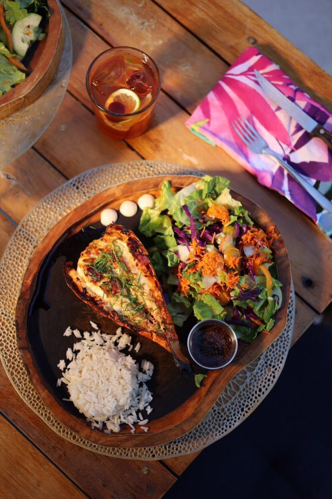 A grilled lobster plate with rice and salad