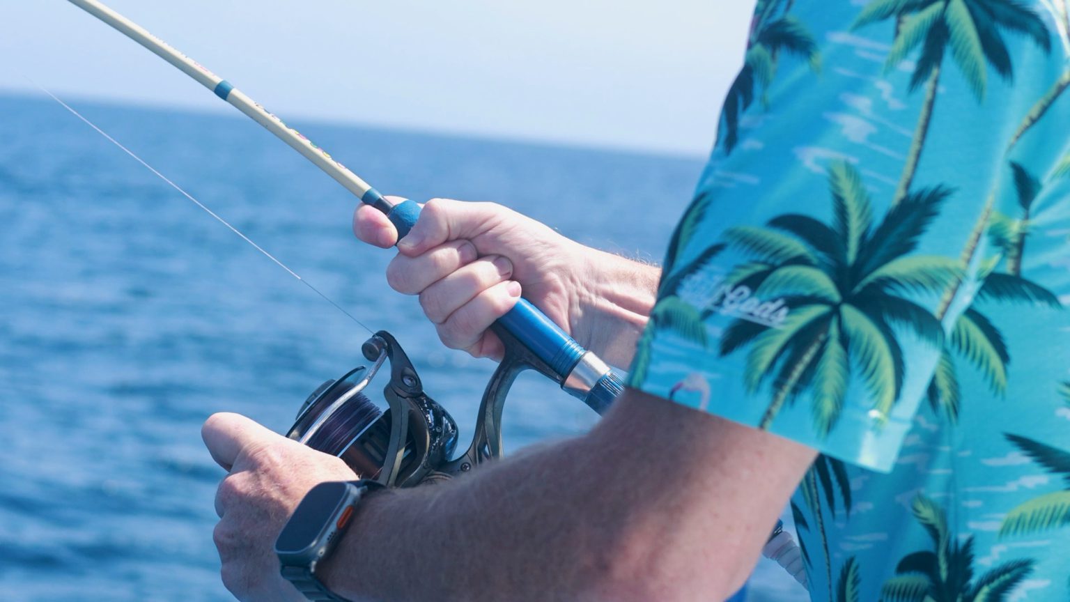 Sport fishing off Mahahual, reel in hand